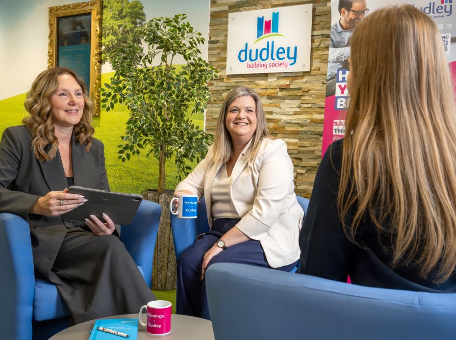 Smiling business service advisors discussing business savings options with a customer