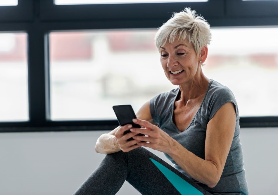 Smiling woman checking her business savings account using a mobile phone